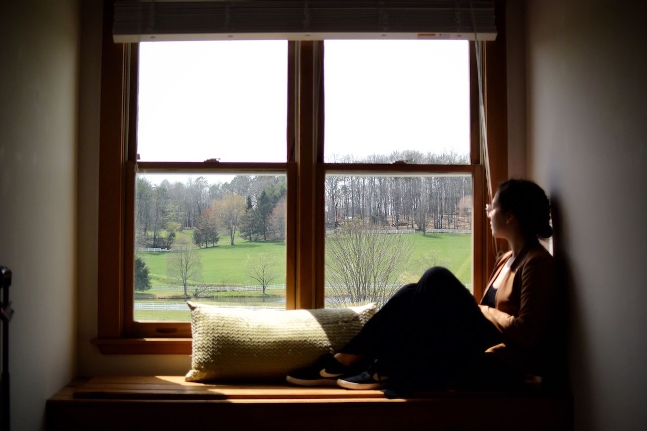 Person looking out of window at Horse Shoe Farm